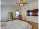Cozy primary bedroom featuring hardwood floors, an ensuite workspace, and a ceiling fan for added comfort at 4350 E Abraham Ln, Phoenix, AZ 85050