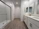 Bright bathroom features a double sink vanity, a separate shower with glass door, and tile floors at 4439 S 95Th Dr, Tolleson, AZ 85353