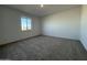 Comfortable bedroom with neutral carpet and a large window providing natural light at 4439 S 95Th Dr, Tolleson, AZ 85353