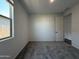 Bright bedroom featuring carpet and a view of a block wall from the window at 4439 S 95Th Dr, Tolleson, AZ 85353