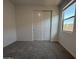 Bright bedroom with carpet and a window with a view of a block wall at 4439 S 95Th Dr, Tolleson, AZ 85353