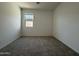 Clean bedroom with plush carpet, white walls, and a window with natural light at 4439 S 95Th Dr, Tolleson, AZ 85353