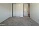 Spacious bedroom with plush carpet, white walls, and a closet at 4439 S 95Th Dr, Tolleson, AZ 85353