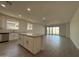 Open-concept kitchen and living area with wood-look flooring and modern finishes at 4439 S 95Th Dr, Tolleson, AZ 85353