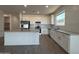 Bright kitchen with stainless steel appliances, center island, and white cabinets at 4439 S 95Th Dr, Tolleson, AZ 85353