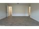 Large living room featuring wood-look tile flooring and neutral paint at 4439 S 95Th Dr, Tolleson, AZ 85353