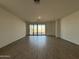 Spacious, well-lit living room with sliding glass doors that provide access to the backyard at 4439 S 95Th Dr, Tolleson, AZ 85353