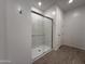 Walk-in shower with sliding glass door and chrome fixtures at 4439 S 95Th Dr, Tolleson, AZ 85353