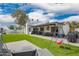 Spacious backyard features a covered patio, lush green lawn and a playful swing set, perfect for outdoor enjoyment at 4839 W Juniper Ave, Glendale, AZ 85306