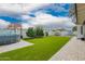 The backyard features a luscious green lawn, lovely landscaping, and string lights at 4839 W Juniper Ave, Glendale, AZ 85306