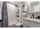 Bright bathroom features shower over tub, subway tile, and modern fixtures at 4839 W Juniper Ave, Glendale, AZ 85306