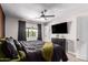 This main bedroom boasts a ceiling fan, television, and a window that offers natural light at 4839 W Juniper Ave, Glendale, AZ 85306