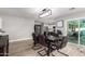 Open dining area with a dark wood table and modern light fixture, connected to the kitchen at 4839 W Juniper Ave, Glendale, AZ 85306