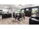 Open-concept dining area next to kitchen boasts a chic light fixture and view of a cozy fireplace at 4839 W Juniper Ave, Glendale, AZ 85306