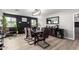 Elegant dining room featuring modern lighting, a dark fireplace, and hardwood floors at 4839 W Juniper Ave, Glendale, AZ 85306