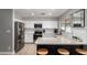 Bright and modern kitchen features white cabinets, stainless steel appliances, and a stylish breakfast bar at 4839 W Juniper Ave, Glendale, AZ 85306