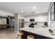 Open concept kitchen with white cabinetry, a breakfast bar, and stainless steel appliances at 4839 W Juniper Ave, Glendale, AZ 85306
