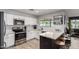 Bright kitchen with white cabinets, stainless steel appliances, and quartz countertops at 4839 W Juniper Ave, Glendale, AZ 85306