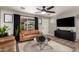 Modern living room with black accents, tan furniture, and a sleek entertainment center at 4839 W Juniper Ave, Glendale, AZ 85306
