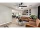 Cozy living room featuring sleek furniture, stylish decor, and a multi-blade ceiling fan at 4839 W Juniper Ave, Glendale, AZ 85306