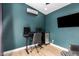 This office features a desk and multiple monitors and is painted in a lovely dark teal at 4839 W Juniper Ave, Glendale, AZ 85306