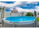 Inviting above-ground pool, set against a backdrop of a bright blue sky, perfect for summer relaxation at 4839 W Juniper Ave, Glendale, AZ 85306