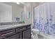 Bathroom features dark wood vanity cabinets, granite countertops, and a shower/bath combo at 4876 N 207Th Ln, Buckeye, AZ 85396
