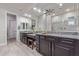 Bright bathroom with granite countertops, dual sinks, glass shower and walk-in closet at 4876 N 207Th Ln, Buckeye, AZ 85396