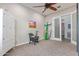 A spacious bedroom with chair, ceiling fan, and frosted glass sliding doors at 4876 N 207Th Ln, Buckeye, AZ 85396