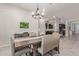 The dining area is open to the kitchen, features backyard views, and a stylish pendant light at 4876 N 207Th Ln, Buckeye, AZ 85396
