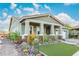 Charming single-story home features a desert-style rock garden, a small artificial grass lawn, and a covered porch at 4876 N 207Th Ln, Buckeye, AZ 85396