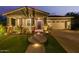 Inviting home featuring desert landscaping, a well-lit brick pathway, and a covered porch at 4876 N 207Th Ln, Buckeye, AZ 85396