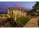 Beautiful Southwestern home with desert landscaping and a well manicured lawn at 4876 N 207Th Ln, Buckeye, AZ 85396