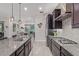 Kitchen features granite countertops, stainless steel appliances, dark wood cabinetry, and an open layout at 4876 N 207Th Ln, Buckeye, AZ 85396