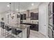 The kitchen boasts stainless steel appliances, a large island, ample counter space, and pendant lighting at 4876 N 207Th Ln, Buckeye, AZ 85396