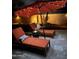Cozy backyard lounge area with stylish patio furniture and ambient lighting, perfect for evening relaxation at 4876 N 207Th Ln, Buckeye, AZ 85396