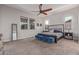 Spacious main bedroom featuring plush carpeting, a ceiling fan, an accent wall, and plenty of natural light at 4876 N 207Th Ln, Buckeye, AZ 85396