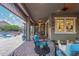 Spacious covered patio with stylish furniture and pool access, ideal for relaxing and entertaining guests at 4876 N 207Th Ln, Buckeye, AZ 85396