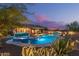 Inviting backyard with a private pool, spa, outdoor bar and covered seating area at 4876 N 207Th Ln, Buckeye, AZ 85396