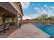 Elegant outdoor living space featuring a covered patio with a pool view and comfortable seating at 4876 N 207Th Ln, Buckeye, AZ 85396