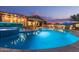 Stunning pool with a built-in spa and ample seating for relaxing or entertaining in the backyard at 4876 N 207Th Ln, Buckeye, AZ 85396