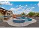 Stunning backyard with a large pool, spa, bar, and outdoor kitchen, great for entertaining guests at 4876 N 207Th Ln, Buckeye, AZ 85396