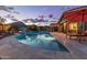 The backyard oasis features a private pool, spa, lounge chairs, and covered outdoor seating at 4876 N 207Th Ln, Buckeye, AZ 85396