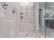 Walk-in shower boasts large stone-patterned tile, built-in seat and shelves at 4876 N 207Th Ln, Buckeye, AZ 85396