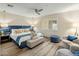 Cozy bedroom featuring a blue upholstered bed, a ceiling fan, and plantation shutters at 5104 N 32Nd St # 105, Phoenix, AZ 85018