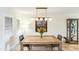 Bright dining room with a rustic table, modern lighting, and a display cabinet at 5104 N 32Nd St # 105, Phoenix, AZ 85018