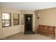 Cozy building entrance featuring a decorative security door, a wooden bench, and a small window at 5104 N 32Nd St # 105, Phoenix, AZ 85018