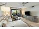 Bright living room featuring hardwood floors, a ceiling fan, and sliding door access to the patio at 5104 N 32Nd St # 105, Phoenix, AZ 85018