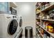 Pantry and laundry area featuring ample shelving and modern appliances at 5104 N 32Nd St # 105, Phoenix, AZ 85018