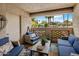 Relaxing patio with blue cushioned wicker furniture overlooking lush landscaping at 5104 N 32Nd St # 105, Phoenix, AZ 85018